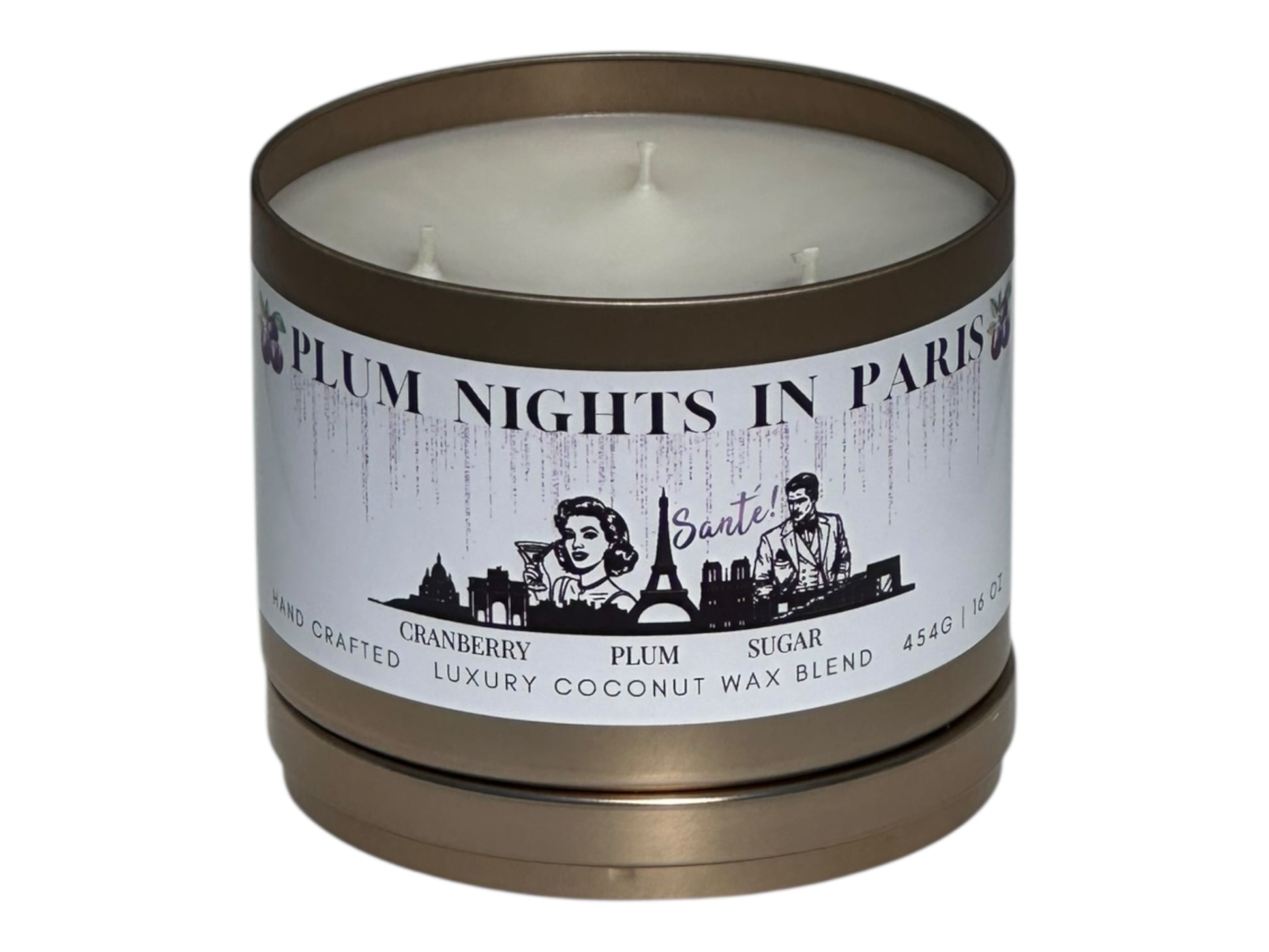 A gold candle tin labeled "Plum Nights in Paris" on a white background front view with candle lid removed and sitting underneath the candle.