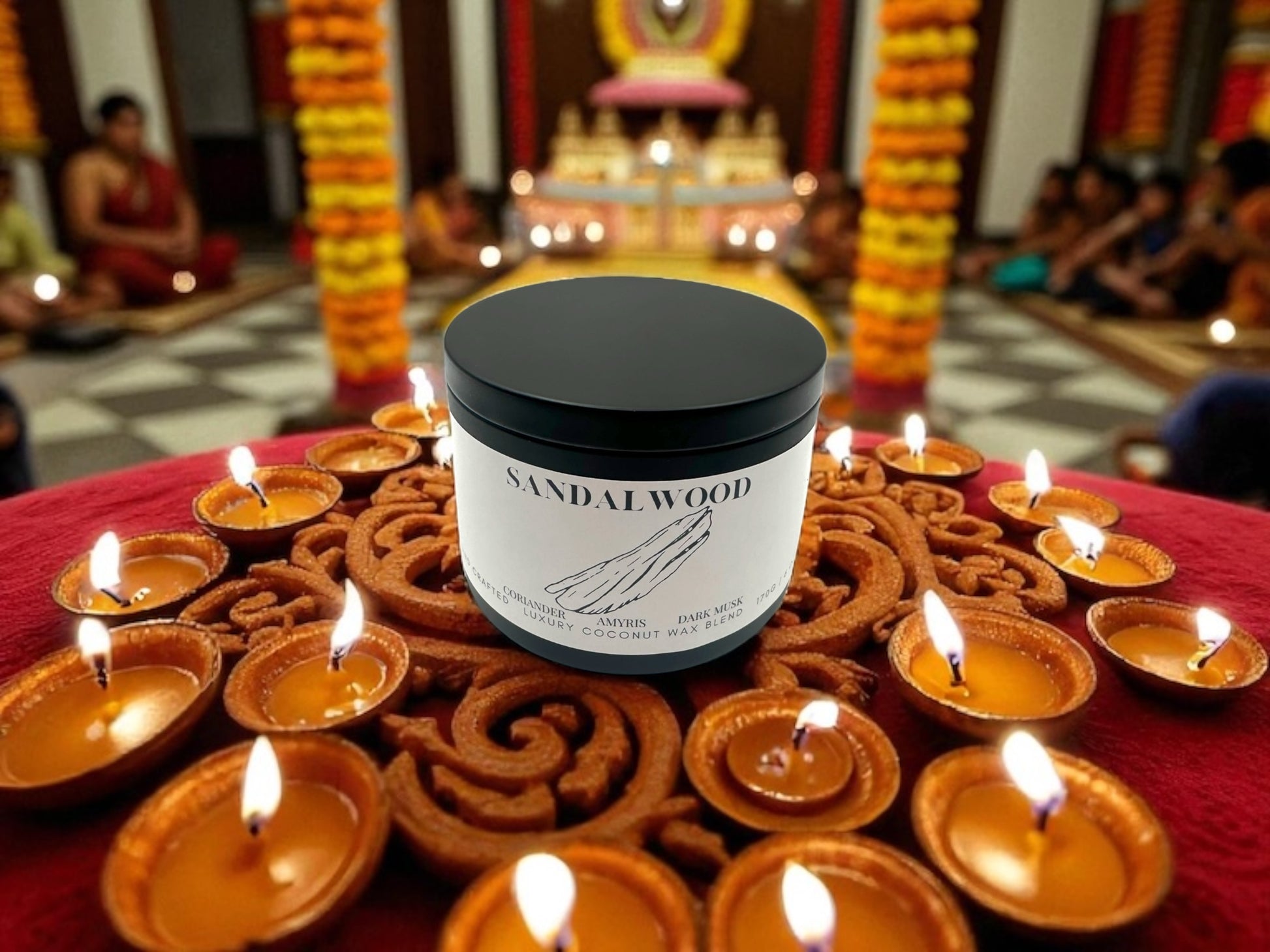Sandalwood black candle tin with a background of Diwali decorations.