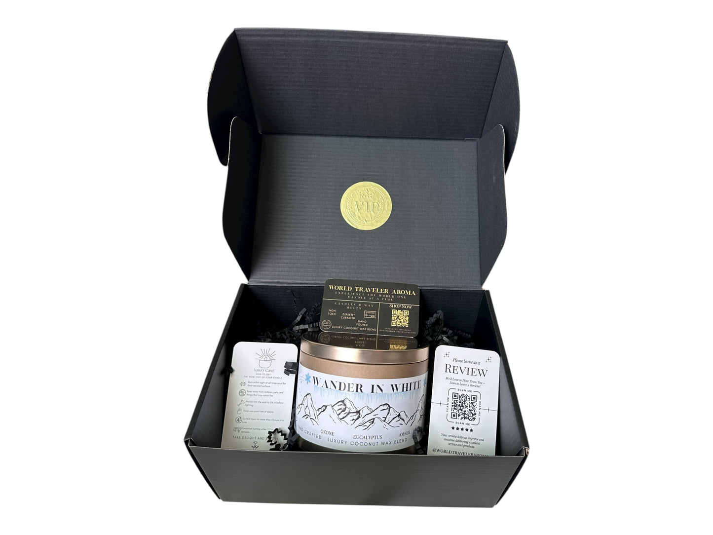 Gift box with a candle labeled 'Wander in White' on a white background